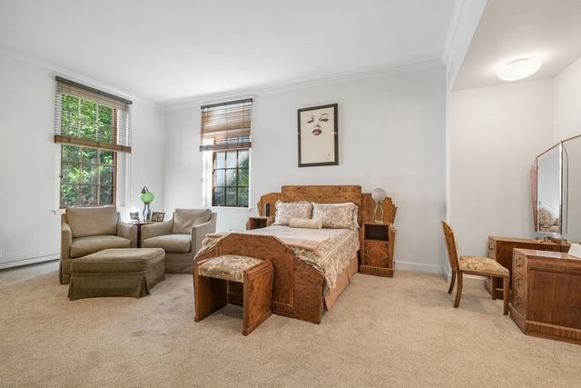 a spacious bathroom with a tub shower and mirror