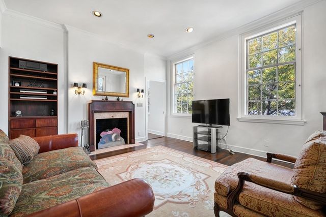 a kitchen with a sink window and a television