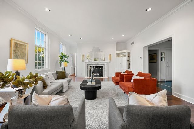 a living room with furniture fireplace and a window