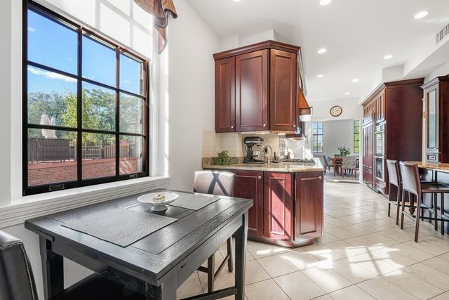 a kitchen with a sink a stove and chairs