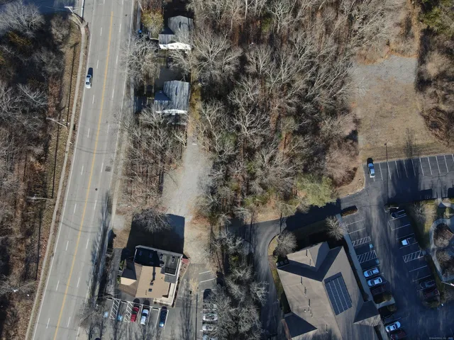 a backyard of a house with outdoor seating and trees