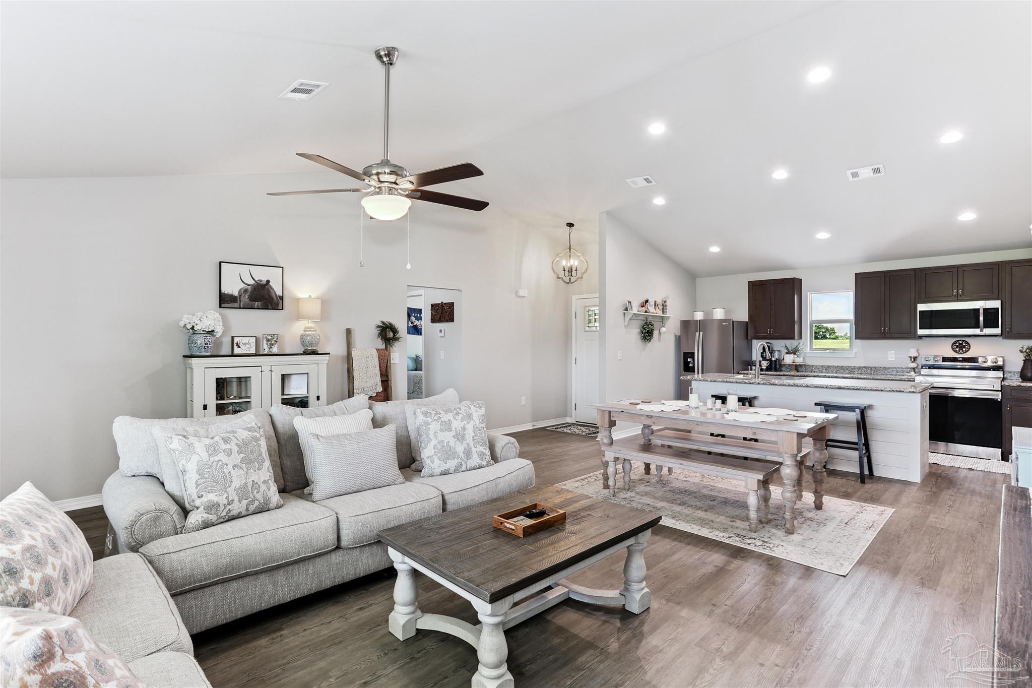 3545 Godwin Road Jay, FL 32565 - Photo 7 of 24 a living room with furniture kitchen view and a chandelier