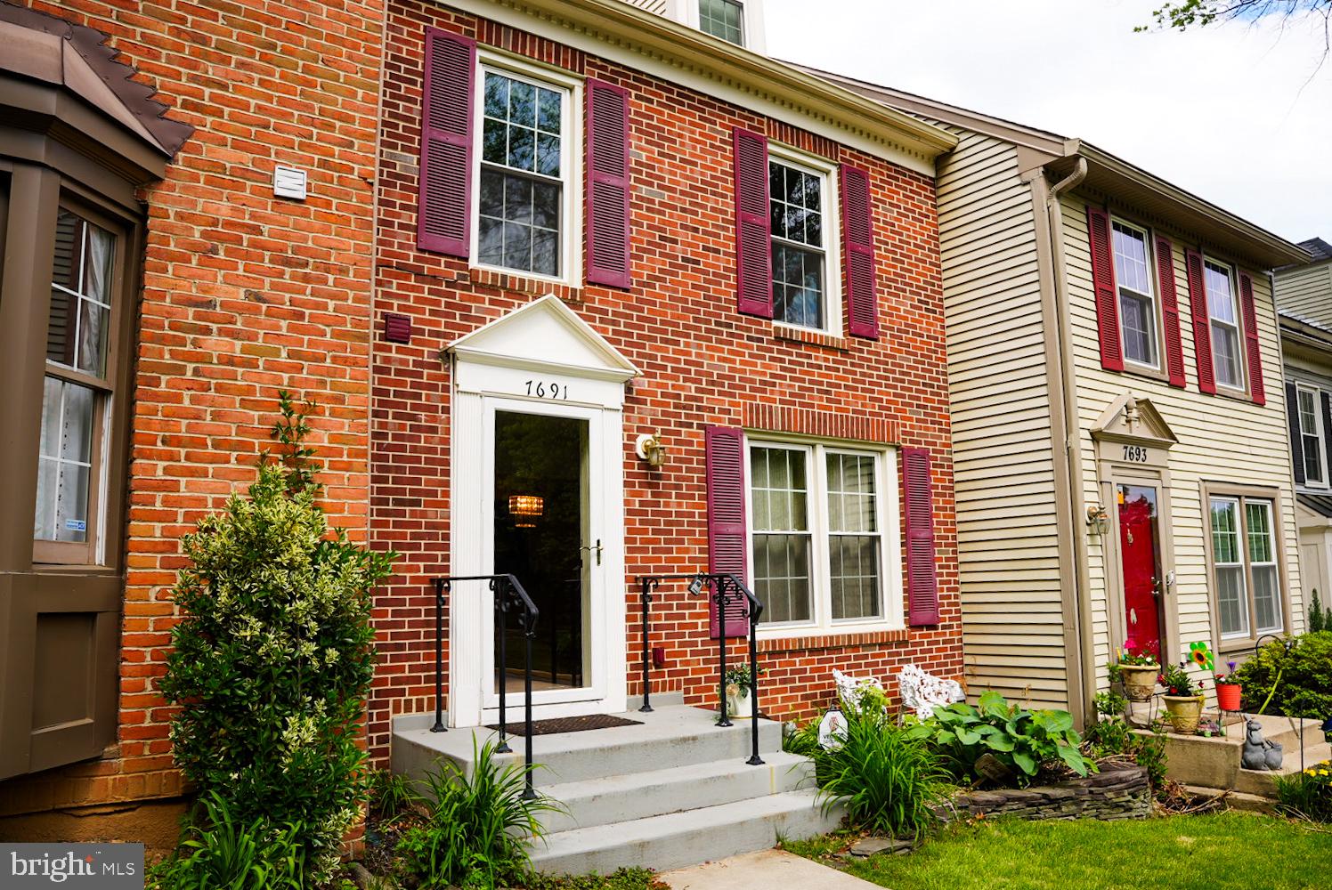 7691 Northern Oaks Court Springfield, VA 22153 - Photo 1 of 23 Charming brick facade with vibrant shutters.