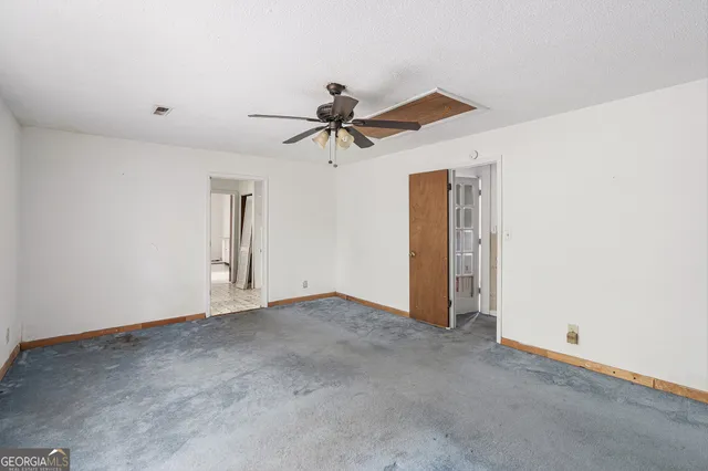 a view of a livingroom with a ceiling fan and window
