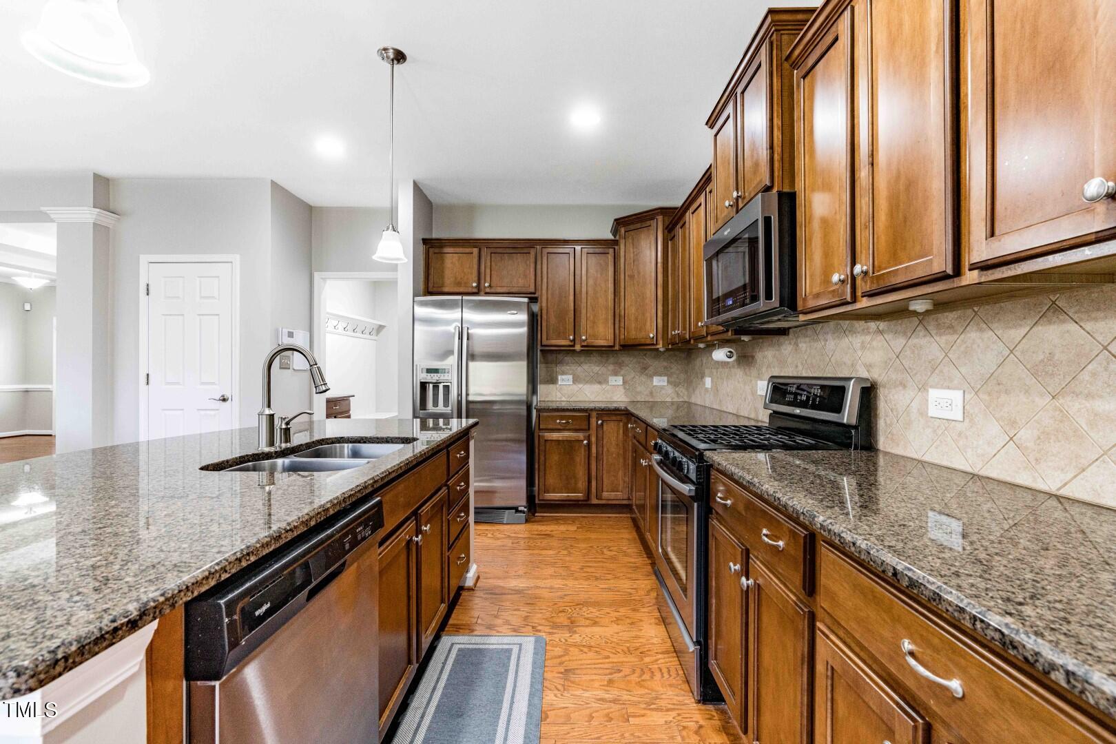 1017 Lakeview Road Durham, NC 27712 - Photo 11 of 32 a kitchen with stainless steel appliances granite countertop a sink a stove and cabinets