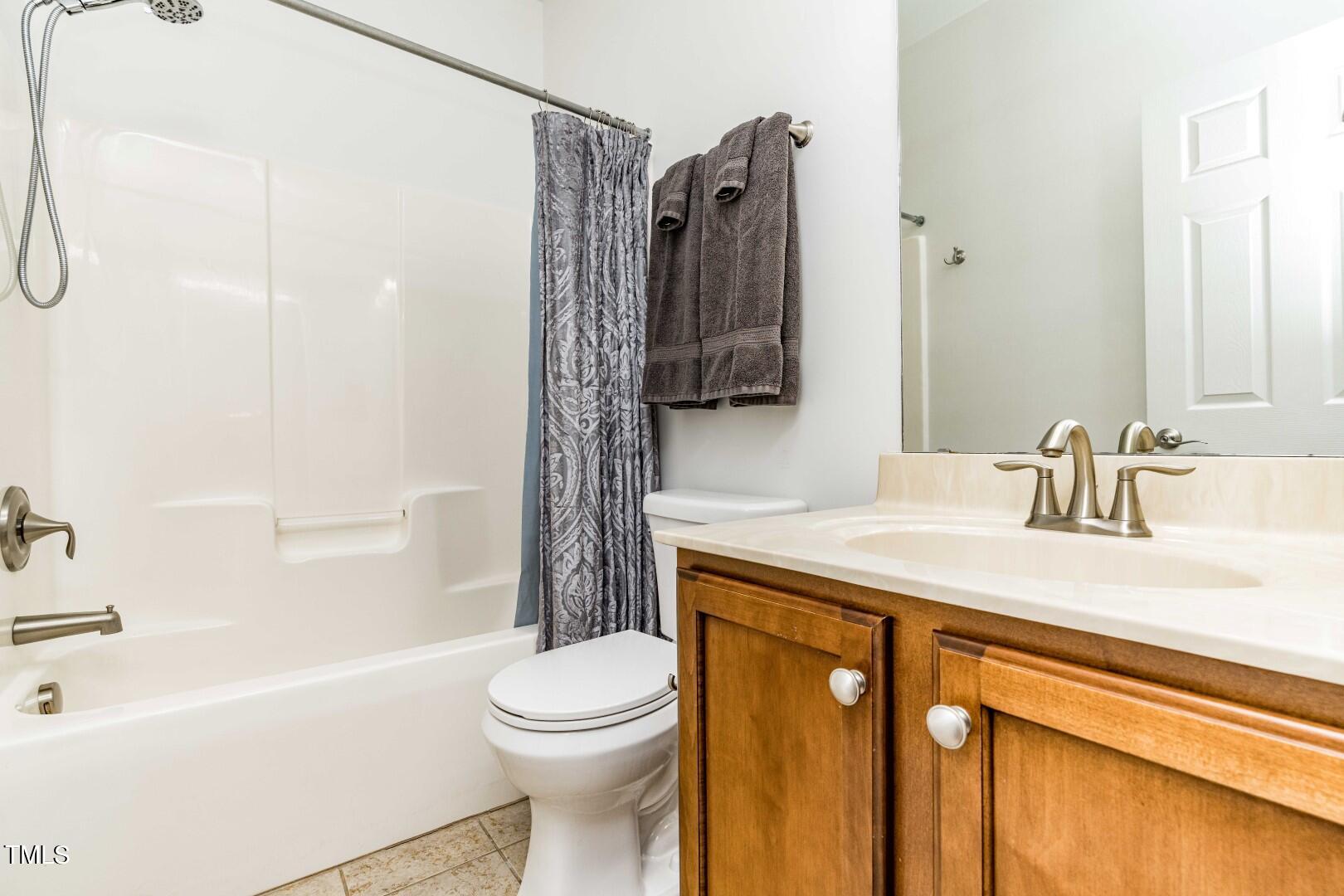 1017 Lakeview Road Durham, NC 27712 - Photo 13 of 32 a bathroom with a sink a toilet and shower