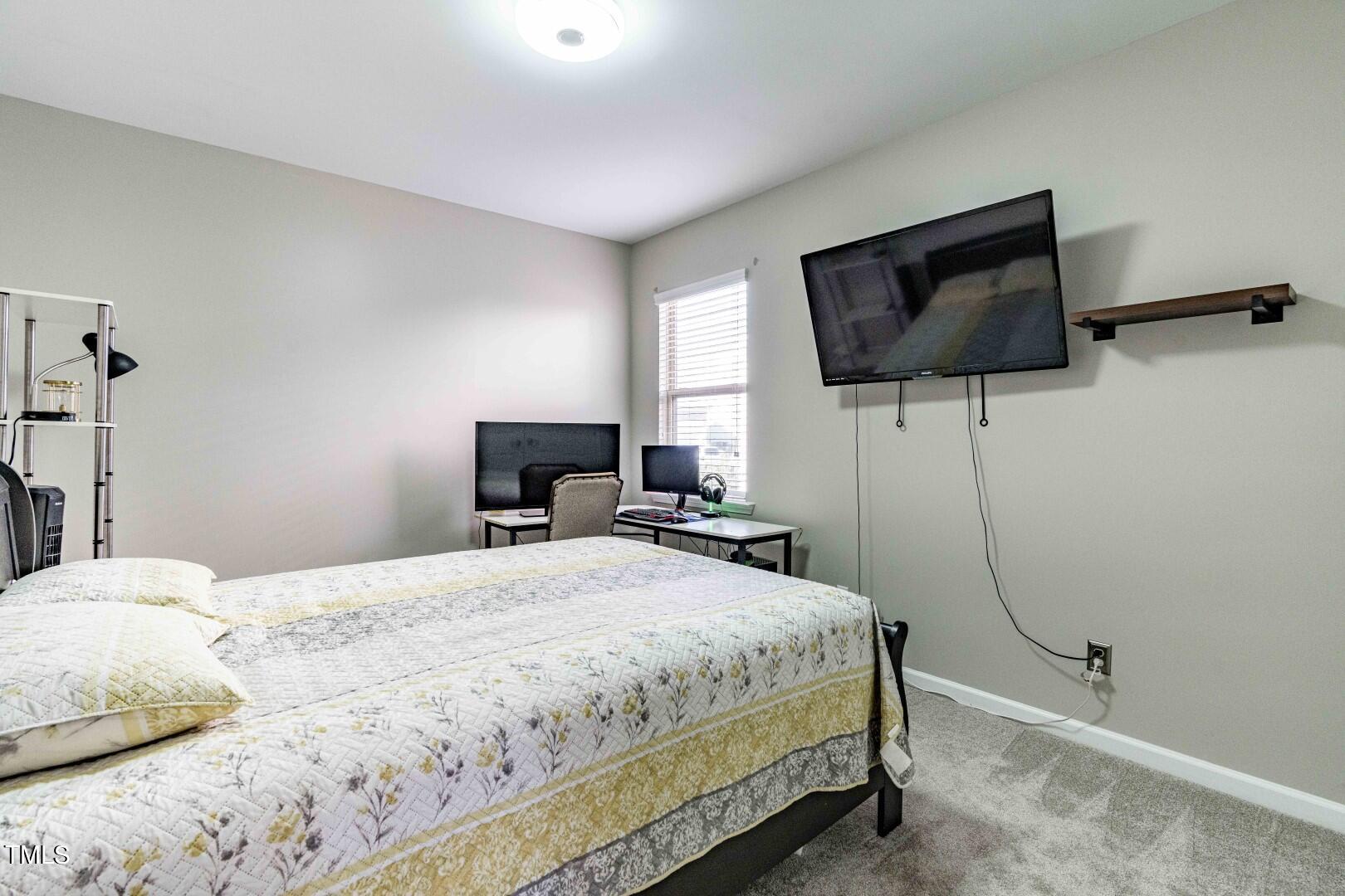 1017 Lakeview Road Durham, NC 27712 - Photo 14 of 32 a bedroom with a bed and a flat screen tv