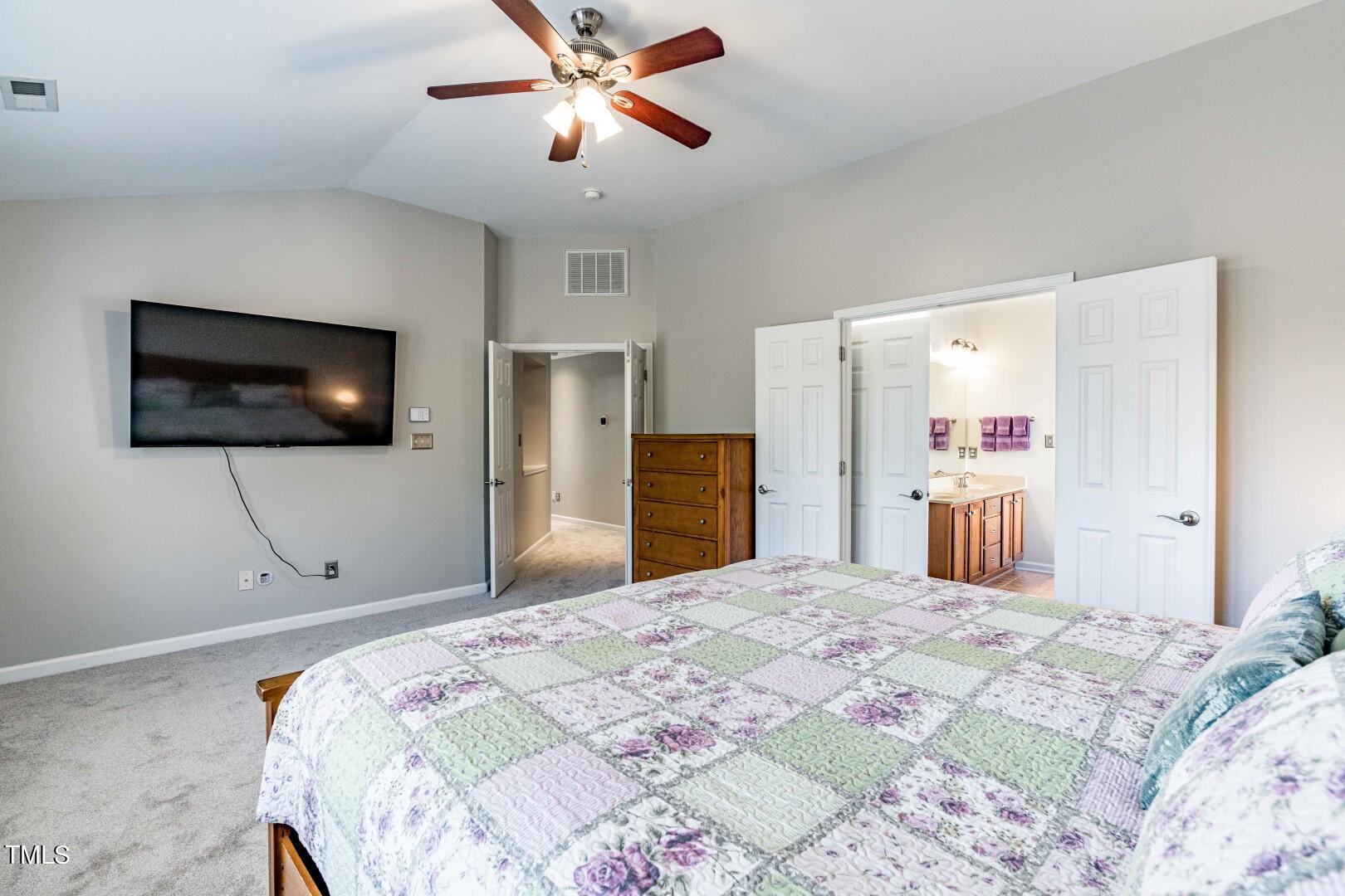 1017 Lakeview Road Durham, NC 27712 - Photo 16 of 32 a bedroom with a bed and a flat screen tv