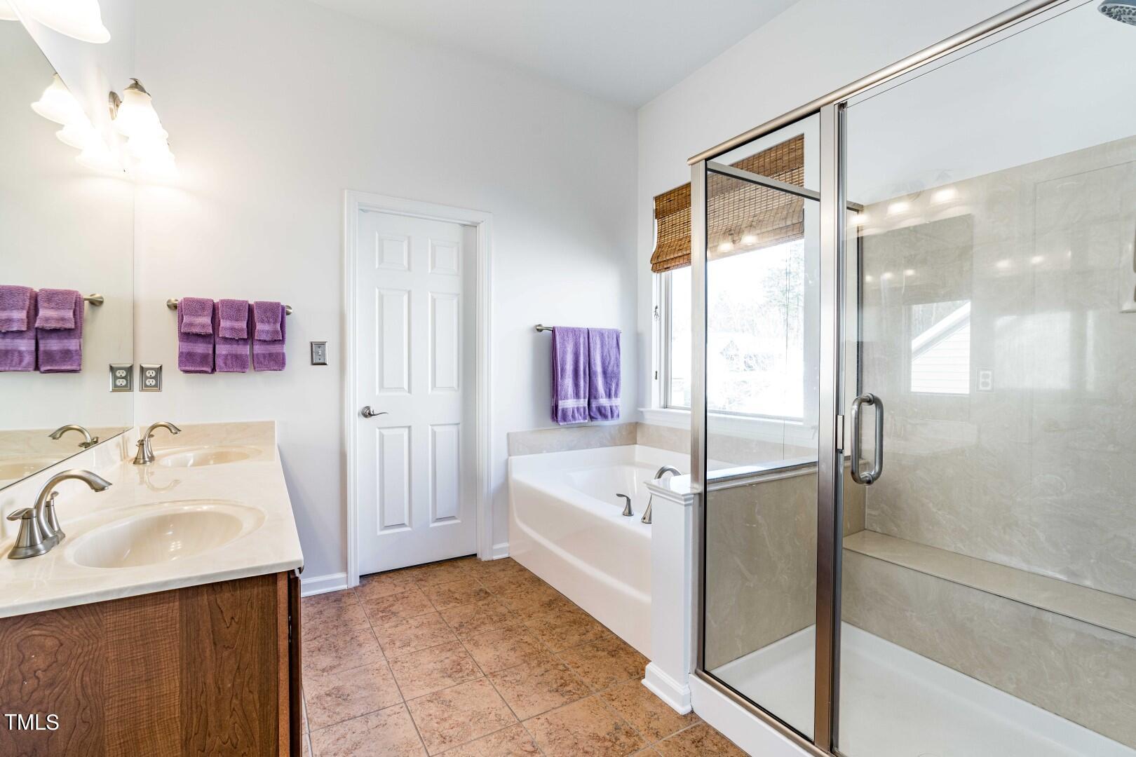 1017 Lakeview Road Durham, NC 27712 - Photo 18 of 32 a bathroom with a tub sink shower and mirror