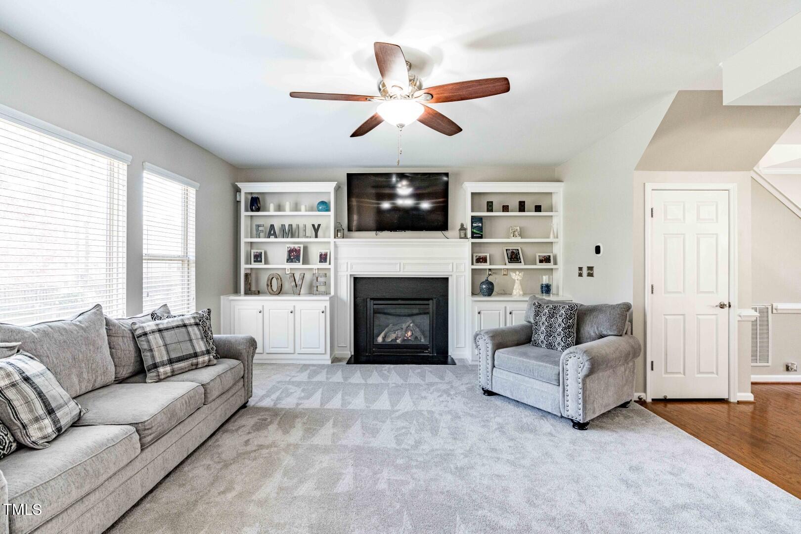 1017 Lakeview Road Durham, NC 27712 - Photo 6 of 32 a living room with furniture a flat screen tv and a fireplace