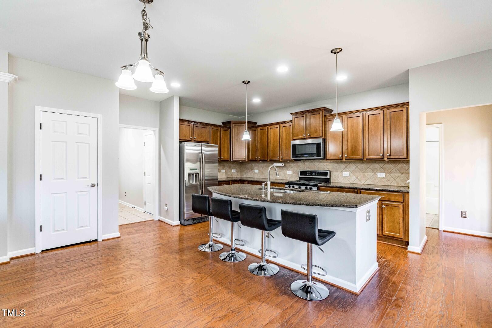 1017 Lakeview Road Durham, NC 27712 - Photo 8 of 32 a view of kitchen with granite countertop refrigerator stove dining table and chairs