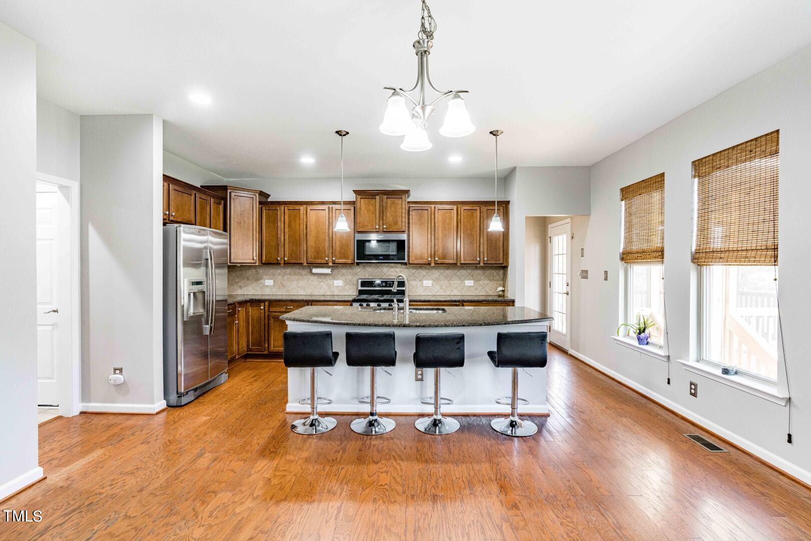 1017 Lakeview Road Durham, NC 27712 - Photo 9 of 32 a view of kitchen with refrigerator microwave and cabinets