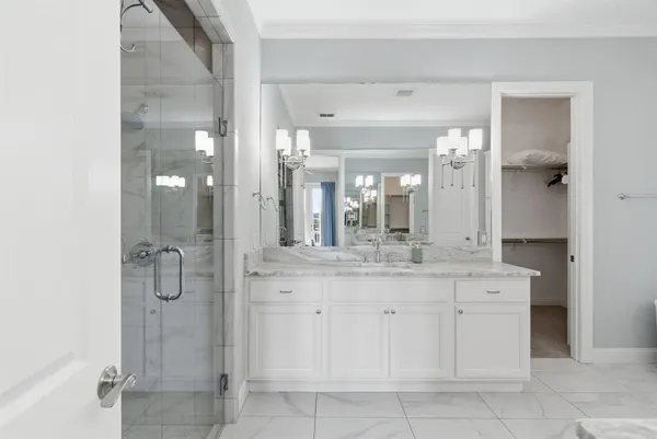 a bathroom with a granite countertop sink a shower and a mirror