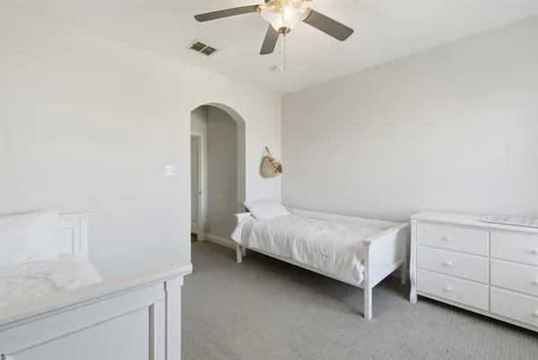 a bedroom with a bed and a dresser