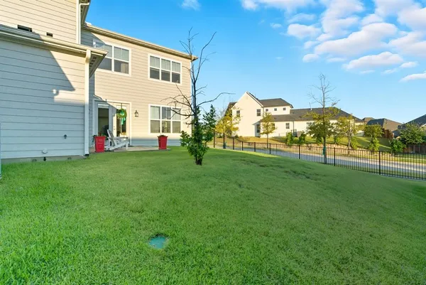 a view of a house with a yard and front view of a house
