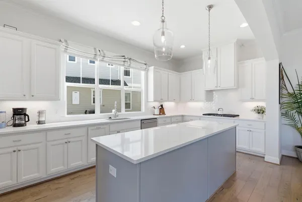 a kitchen with a sink stove and cabinets