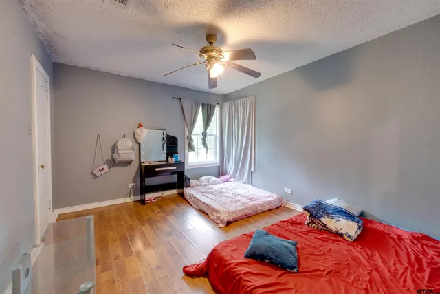 a bedroom with two beds and a chandelier