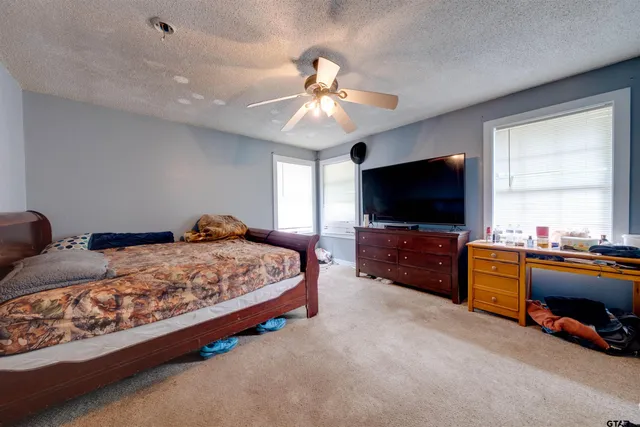 a bedroom with furniture and a flat screen tv
