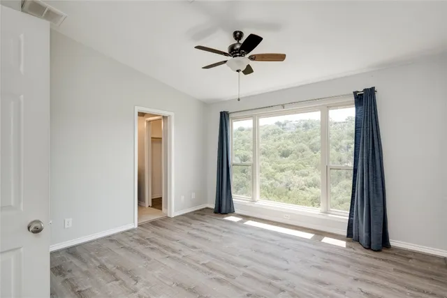 a view of a livingroom with a ceiling fan and window