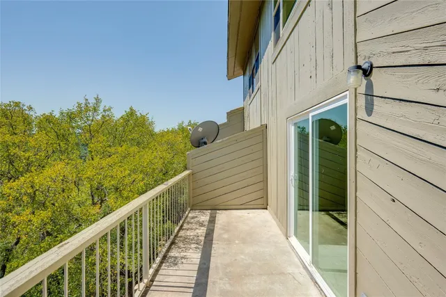 a view of a balcony with wooden floor and stairs