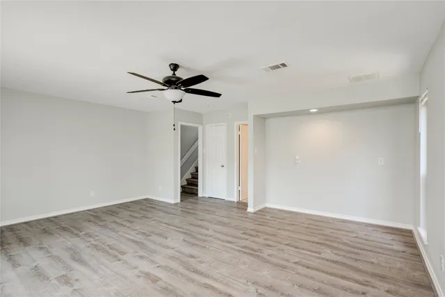 a view of an empty room with a ceiling fan