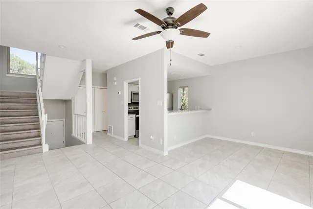 a view of kitchen with microwave and cabinets