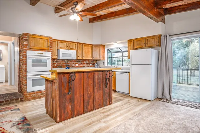 a kitchen with a refrigerator a stove top oven a sink and dishwasher