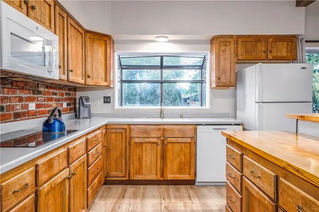 a kitchen with stainless steel appliances granite countertop a sink and a refrigerator