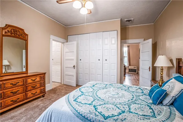 a bedroom with a bed and a dresser in it