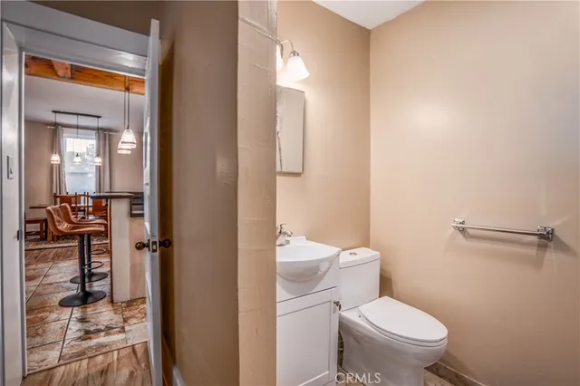 a white toilet sitting next to a bathroom sink