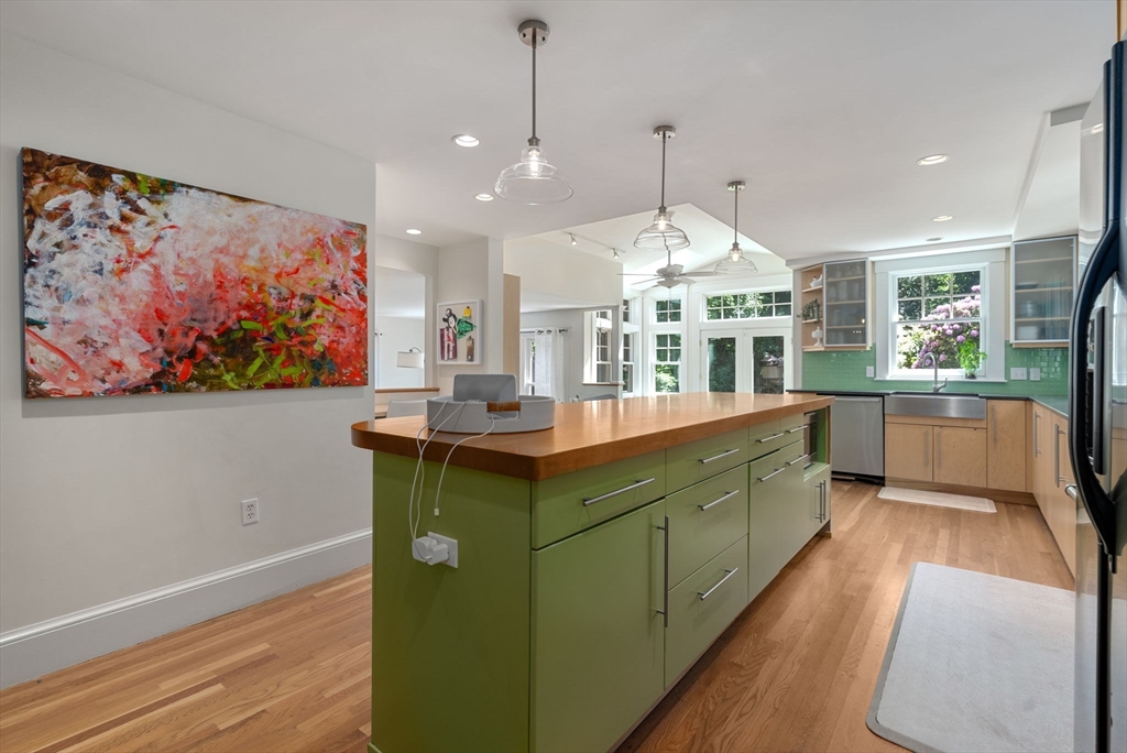 260 Glen Road Weston, MA 02493 - Photo 14 of 42 a kitchen with kitchen island a counter top space a sink stainless steel appliances and cabinets
