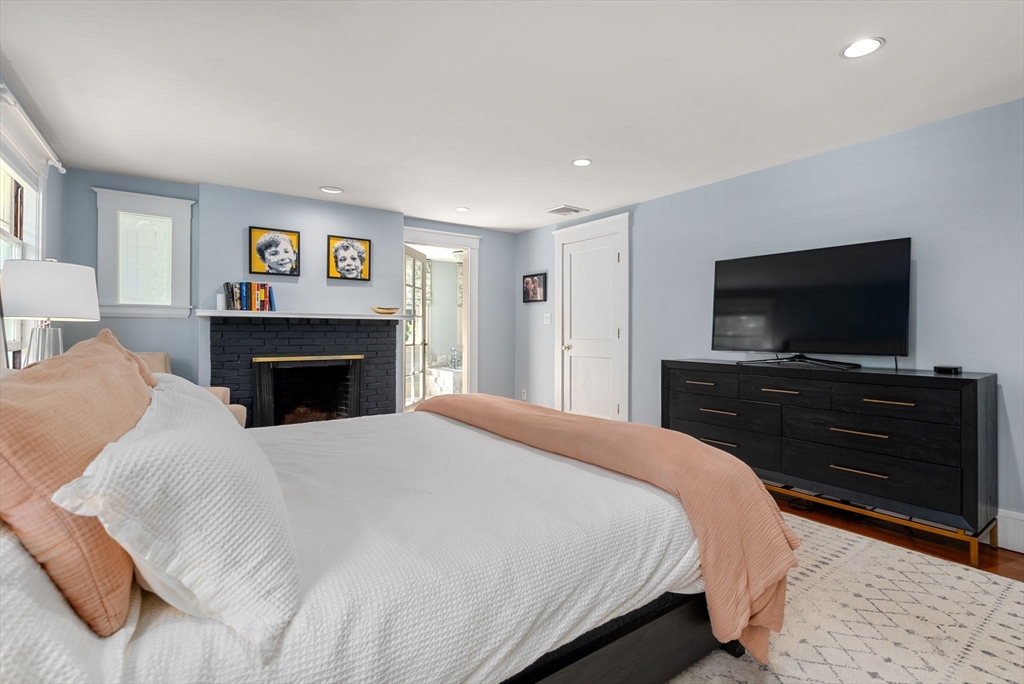 260 Glen Road Weston, MA 02493 - Photo 26 of 42 a bedroom with a bed and a flat screen tv