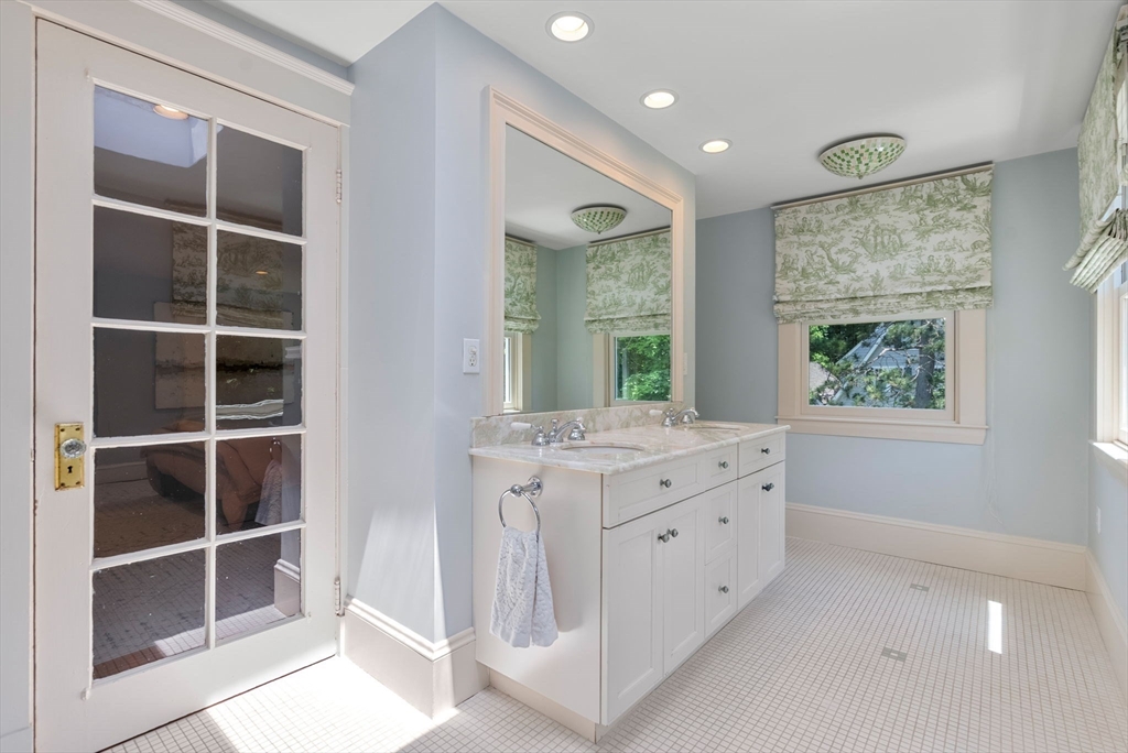 260 Glen Road Weston, MA 02493 - Photo 31 of 42 a bathroom with a granite countertop sink mirror vanity and next to a window