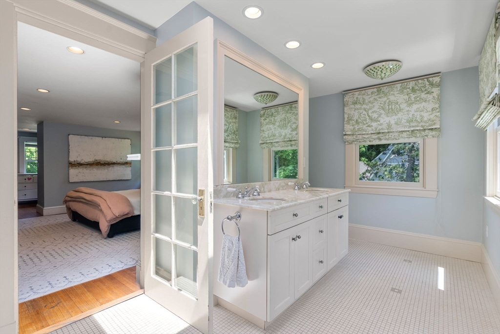 260 Glen Road Weston, MA 02493 - Photo 32 of 42 a en suite bathroom with a granite countertop sink and a large mirror