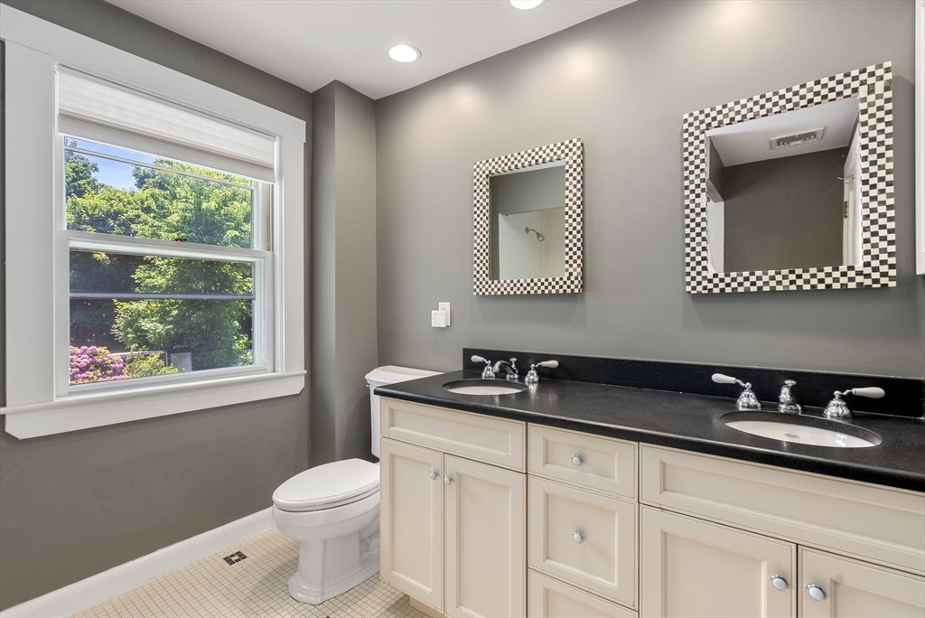 260 Glen Road Weston, MA 02493 - Photo 33 of 42 a bathroom with a toilet a sink a mirror and a window