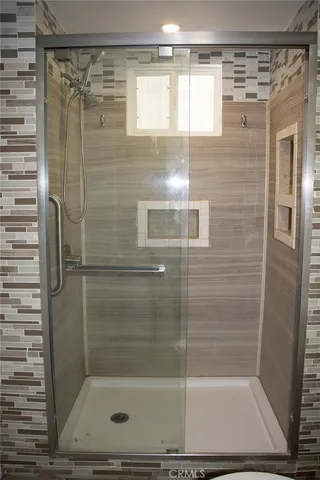 a bathroom with a granite countertop toilet and a sink