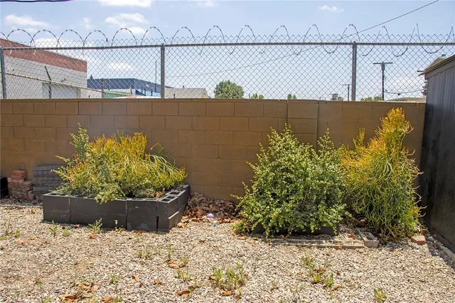a backyard of a house with plants and outdoor seating