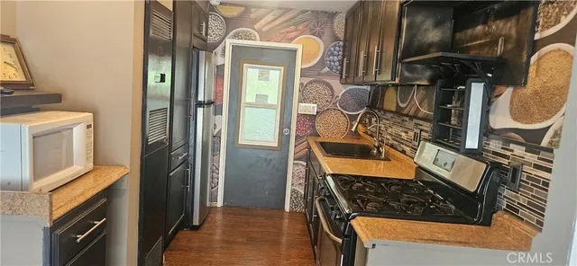 a kitchen with stainless steel appliances granite countertop a stove and a sink