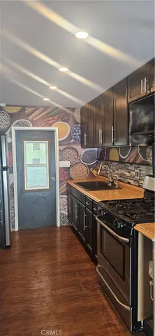 a stove top oven sitting inside of a kitchen