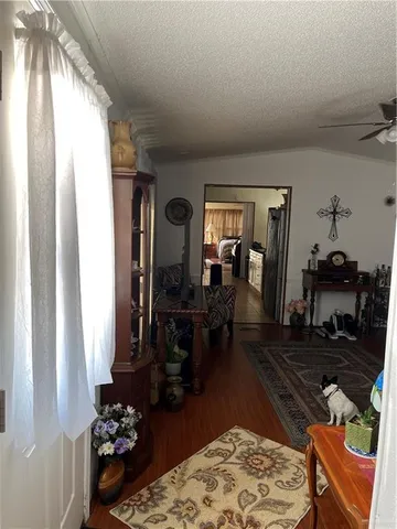 a living room with furniture rug and wooden floor