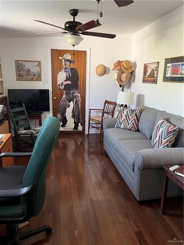 a living room with furniture and wooden floor