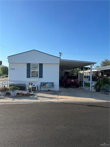 a couple of cars parked in front of a house