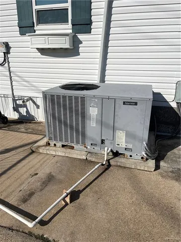 a backyard with a table and chair and barbeque grill