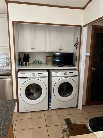 a kitchen with a refrigerator sink and cabinets