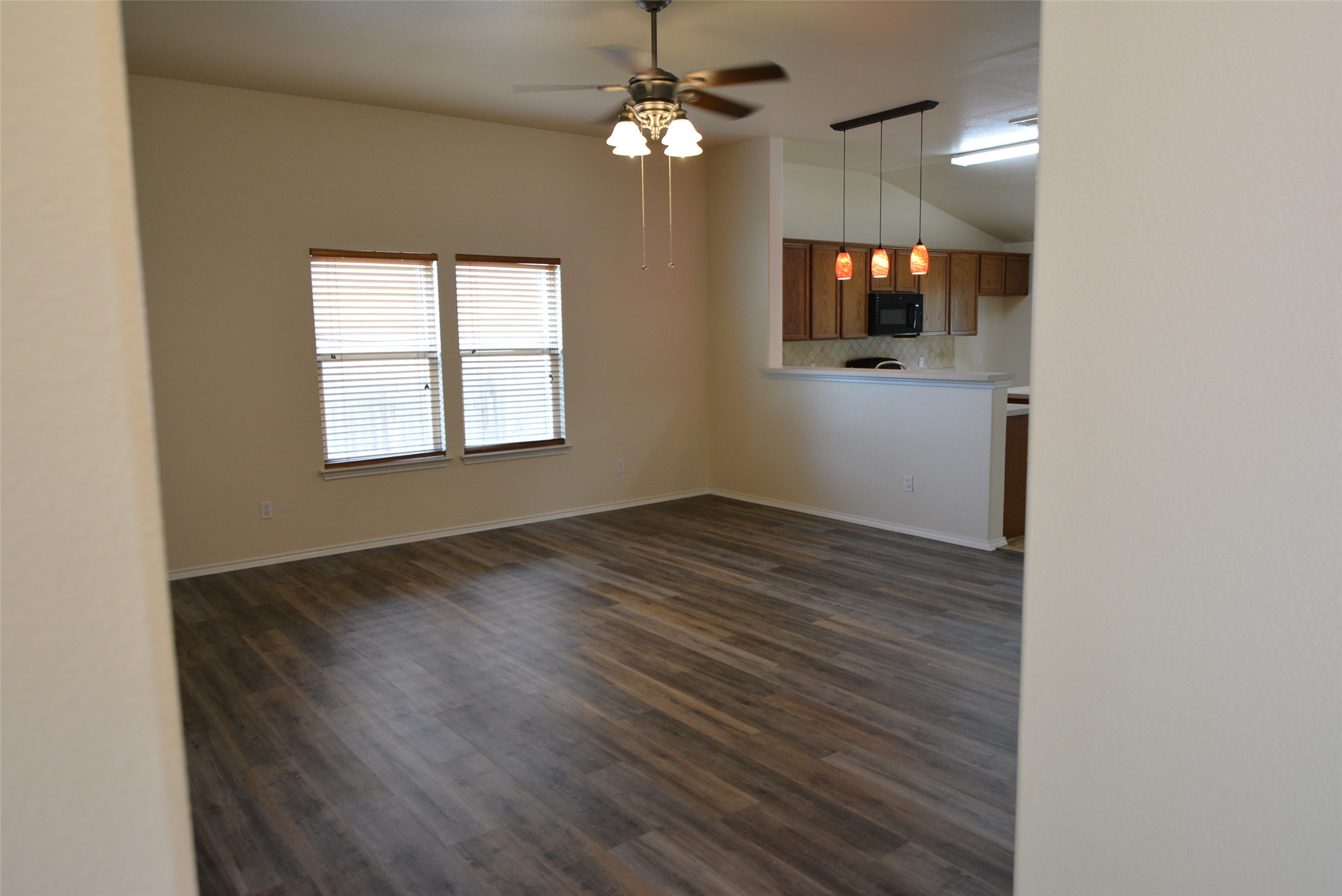 1303 Horseshoe Ranch Drive Leander, TX 78641 - Photo 6 of 26 An open-concept living area with ample lighting seamlessly connects to the kitchen space.