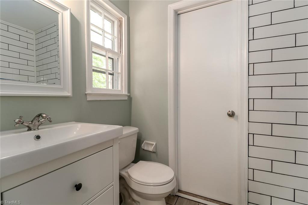 2210 Waynick Street High Point, NC 27265 - Photo 3 of 28 Downstairs remodeled full bathroom with tiled shower.