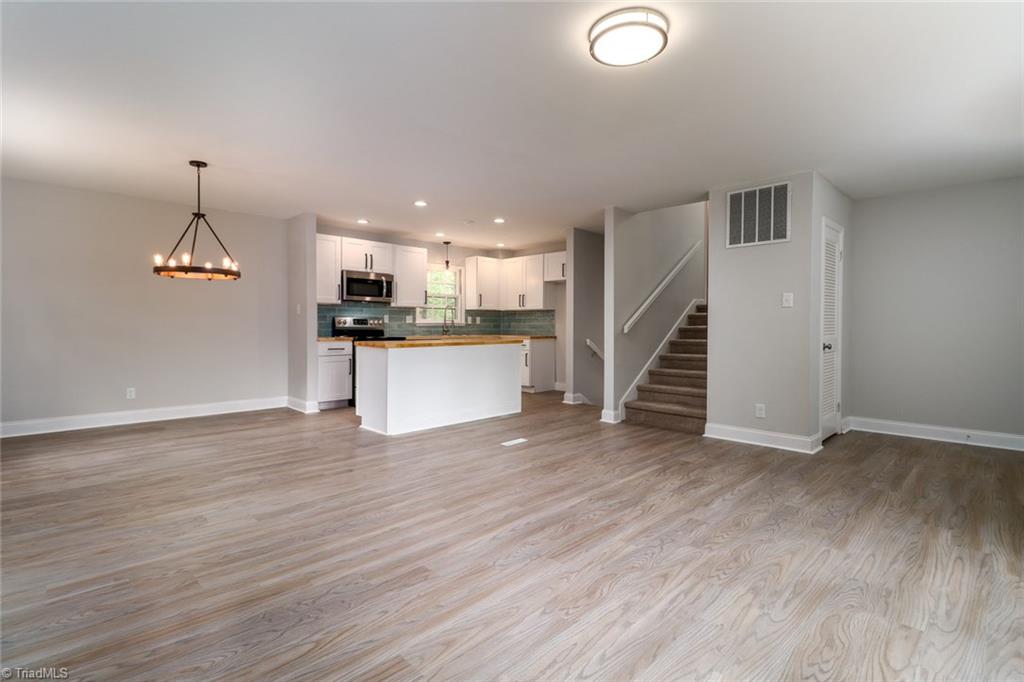2210 Waynick Street High Point, NC 27265 - Photo 6 of 28 Open living room, dining and kitchen with new vinyl flooring.