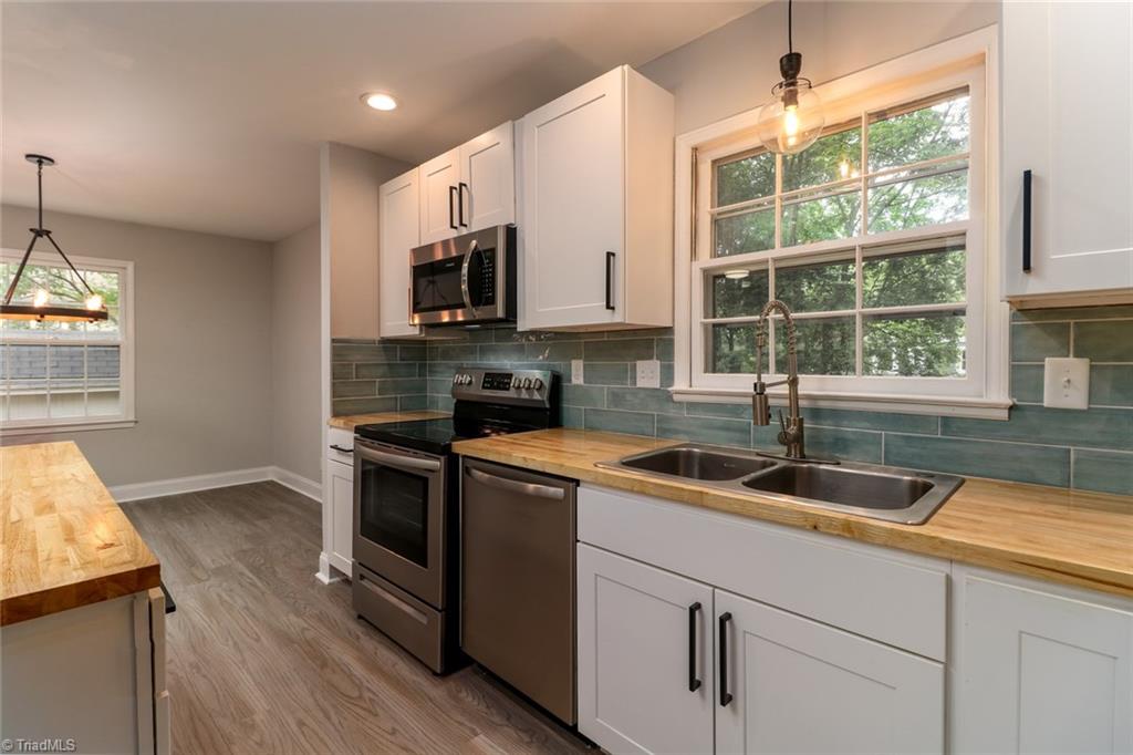 2210 Waynick Street High Point, NC 27265 - Photo 9 of 28 Stove, microwave, dishwasher and double sink.