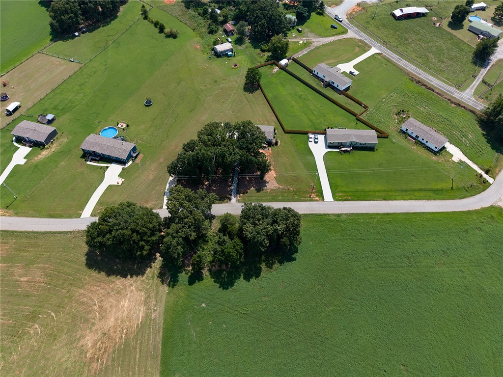 112 Purdy Road Iva, SC 29655 - Photo 28 of 33 Aerial view showcasing sprawling green acreage and neighboring properties nestled along a quiet country road.
