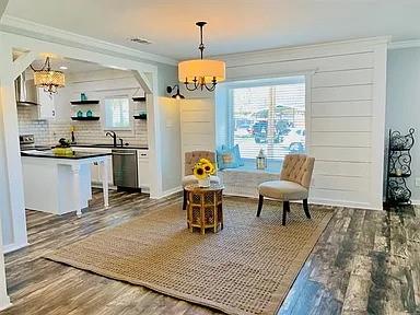 602 South Chestnut Street McKinney, TX 75069 - Photo 3 of 24 a living room with stainless steel appliances furniture a rug and a chandelier